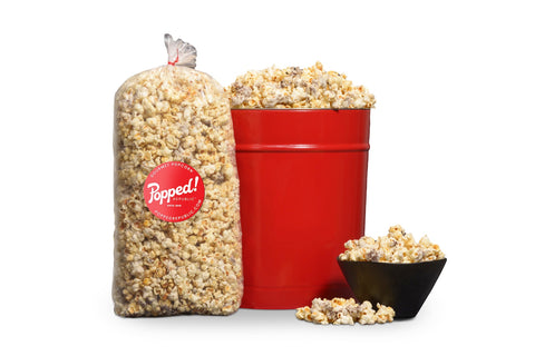 Red bucket and an extra large bulk bag of Cookies and Cream kettle corn from Popped! Republic