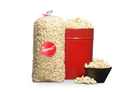 Red bucket and an extra large bulk bag of Gourmet Gluten free Dill Pickle Popcorn from Popped! Republic