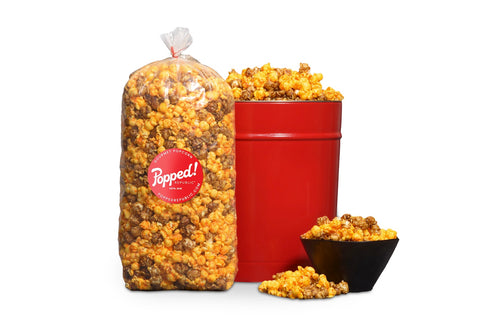 Red bucket and an extra large bulk bag of Cheese and Caramel popcorn mix from Popped! Republic